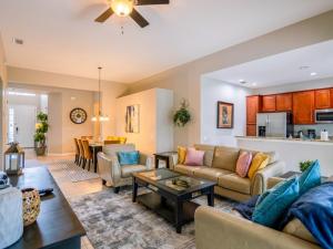 a living room with a couch and a table at Luxury Disney Villa 5BR With Private Pool and Spa (4 Miles from Disney) in Orlando