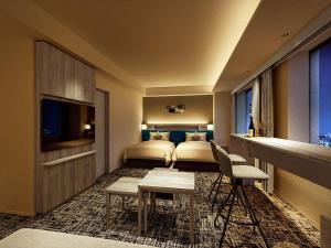 a hotel room with a bedroom with two beds at Lotte City Hotel Kinshicho in Tokyo