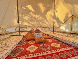 a room with three beds in a tent at TP-HOMES PHAN THIẾT in Phan Thiet