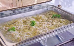 a casserole dish filled with noodles and broccoli at Sky Garden Resort in Dhulikhel