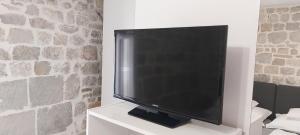 a large flat screen tv sitting on a white cabinet at Antea in Split