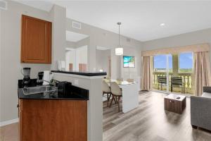 a kitchen and a living room with a kitchen and a dining room at Premier Resort Condos Near Disney & Universal in Orlando
