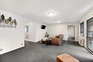 a living room with a couch and a tv at Town centre house. Perfect for families and groups in Queenstown