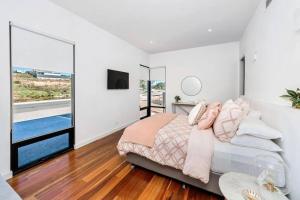 a bedroom with a bed and a large window at 30 Marina Way - Mannum Waters in Mannum