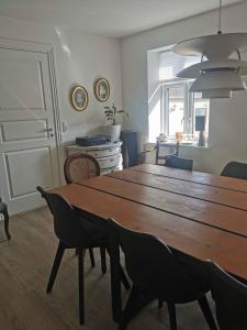 a dining room with a wooden table and chairs at Lovely Farmhouse For The Whole Family in Slagelse