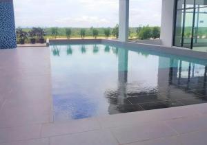 a swimming pool in a building with water at RiverView 8PAX 3BR in KBtown Wi-Fi, B-12-3 in Kota Bharu