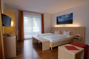 Postel nebo postele na pokoji v ubytování Austria Classic Hotel Heiligkreuz
