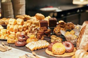 a display of different types of pastries on a table at NOHGA HOTEL KIYOMIZU KYOTO in Kyoto