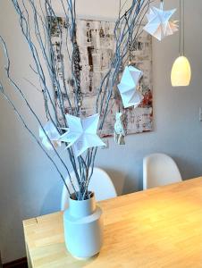 a white vase with stars on a table at Harz is calling in Hahnenklee-Bockswiese