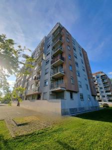a tall apartment building with a lawn in front of it at AppLuna in Zagreb