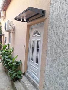 a white door on a building with a window at Dream 3 in Vračar (historical)