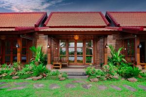 a brick house with a porch and a patio at Dapha Eco Lodge Lovina in Lovina