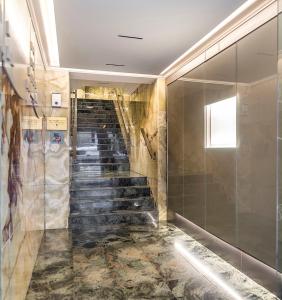 a staircase in a building with marble floors at Hotel Europa in Pamplona