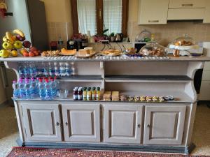 a kitchen counter with a bunch of food and drinks at BnB Villa Melany vicino Centro in Lucca