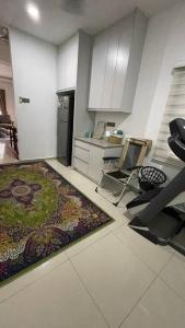 a kitchen with a table and chairs and a rug at Family Homestay 300mbps Internet in Jenjarum