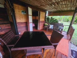 una mesa y sillas en una terraza de madera en Moanaiti Lodge en Maheva