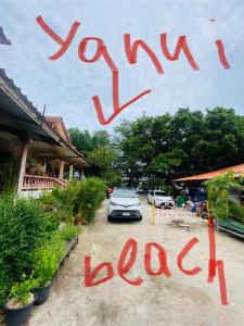 a car parked in a parking lot next to a building at Mandala bungalow at Ya Nui beach in Rawai Beach