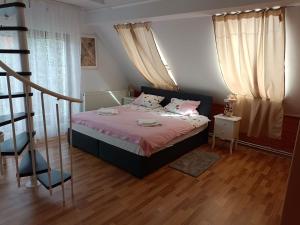 1 dormitorio con cama con sábanas rosas y almohadas rosas en Pension DonauBlick Grein 2 in Stifterstrasse19. (2 Apartment ) en Grein