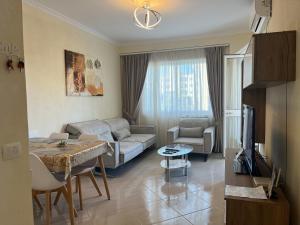 a living room with a couch and a table at Dea Luxury Apartament Beach in Durrës
