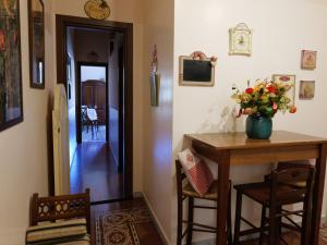 Una habitación con una mesa con un jarrón de flores. en Sweet Suite V&V, en Pompeya