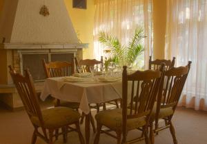 a dining room with a table and chairs and a fireplace at Hotel Zora in Velingrad