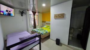 a bedroom with two bunk beds and a window at Hotel la garza roja in Villavicencio