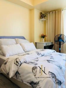a bedroom with a bed with a blanket on it at Jn staycation urban azure in Manila