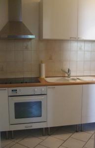 a kitchen with a stove and a sink at Ferienwohnung Mosel-Rhein in Koblenz