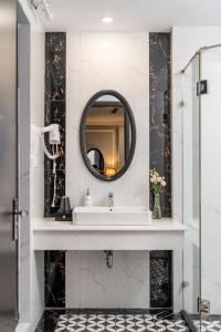 a bathroom with a sink and a mirror at Amara Hanoi Hotel and Spa in Hanoi