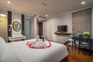 a room with a table with a cake on it at Amara Hanoi Hotel and Spa in Hanoi