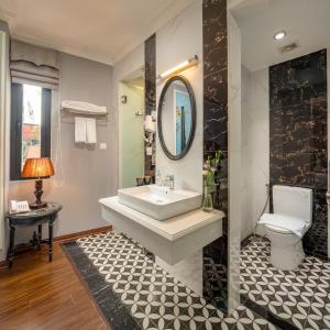 a bathroom with a sink and a toilet at Amara Hanoi Hotel and Spa in Hanoi