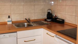 a kitchen with a sink and a counter top at Studio apartment Laura-spacious studio on the main beach in Makarska +43 photos