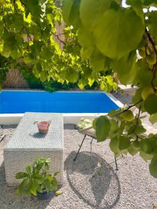 uma mesa e um banco ao lado de uma piscina em Holiday Oasis with private patio and Hammam-style bath in Chora-Pithagoreo, Samos Island em Chóra