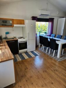 a kitchen and dining room with a table and chairs at Garagelägenhet in Hudiksvall