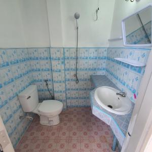 a bathroom with a toilet and a sink at 8 homestel in Koh Tao
