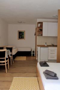 a living room with two beds and a kitchen at Studio apartment Laura-spacious studio on the main beach in Makarska