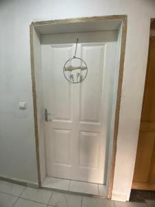 eine weiße Tür mit einem Kronleuchter in einem Zimmer in der Unterkunft Studio meublé à bas prix (salon, chambre, douche, cuisine) in Yasika
