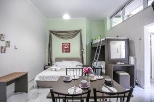 a bedroom with a bed and a table and chairs at Del Sol #1 Meteora Luxurious Family Suites in Kalabaka +19 photos