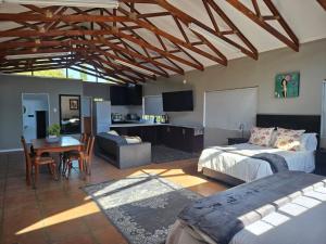 a living room with a bed and a dining room at Lady Smith Self Catering Units in Bloemfontein
