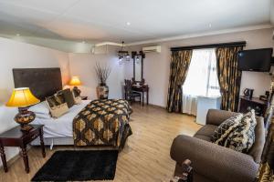 a bedroom with a bed and a couch and a chair at Lavender Hill Country Estate and Wedding Venue in Bethlehem