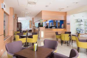 a kitchen with a dining room table and chairs at Hotel Bratislava in Bratislava