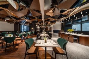 a restaurant with tables and chairs and a ceiling with triangles at Atour Hotel Shanghai City Center ATHOUSE嘉邸 in Shanghai +63 photos