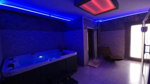 a bathroom with a large tub with blue lights at The Life in Marcellina