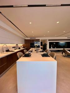 a large kitchen with a long table and chairs at Grand Sapphire Residences By Northernland in İskele +98 photos