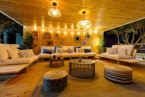 a living room with couches and tables and lights at WaterWheel Villa by Fidalsa in Almoradí