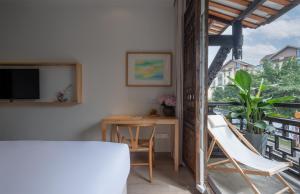 a room with a table and chairs and a window at Mount Emei Heyuan Serene Residence Hot Spring Hotel in Emeishan City