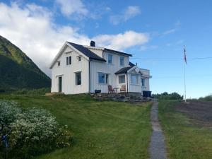 a white house on the side of a hill at This Old House - Check in Breathe out in Strønstad