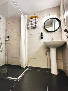 a bathroom with a sink and a mirror at Home Away One Bedroom Apartment in Nicosia in Nicosia