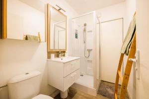 biała łazienka z toaletą i prysznicem w obiekcie Elégant appartement 2 pièces en HyperCentre w mieście Rezé