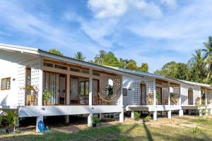 a large white building with large windows at Neverland in Ko Phangan